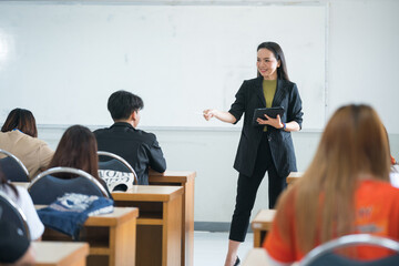 Education, teaching, learning concept. Asian university lecturer teaching lesson to students in...