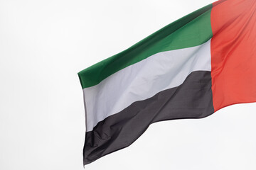 Flag of the United Arab Emirates. A large National UAE flag flutters in the wind. Close-up. Great for news. United Arab Emirates flag on white background