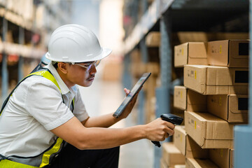 Warehouse employee scans barcodes on boxes in the warehouse. Male worker, warehouse with goods,...