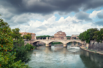 Beautiful clouds above medieval St. Angelo castle and the bridge over Tiber river in Rome, Italy.