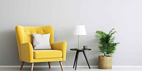 Stylish and luxurious interior with honey yellow armchair, gray frame, gold lamp, mirror, plant, pillow, and elegant accessories. Modern living room decor. Actual image. Template.