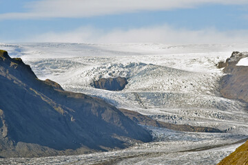 Vatnajokull, the second largest glacier in Europe covering 10% of Iceland, slides down between mountains as it melts.