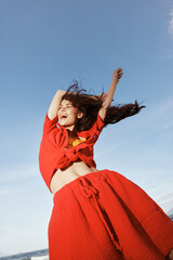 Dancing with Joy: a Smiling Woman Enjoying Sunny Beach Vacation