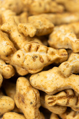 A treat for cats and kittens is a fish-shaped catnip cookie close-up.