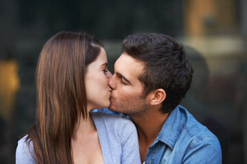 Fototapeta premium Love, kiss and a young couple outdoor for care, commitment and people in connection. Romance, man and woman touch lips together for bonding, trust in relationship and affection on valentines day date