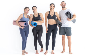 Fototapeta na wymiar Group of happy sporty women and guy wearing body stylish sportswear holding personal carpets leaned on a white background. waiting for yoga class or body weight class. healthy lifestyle and wellness