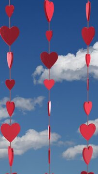 Valentines Day Three Strings of Hearts with Blue Sky Background Vertical