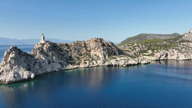 Aerial drone video of beautiful and picturesque cape Melagavi forming a small peninsula with unique lighthouse stand out next to archaeological site of Heraion, Loutraki, Greece