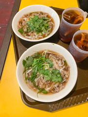 Pho is Vietnamese soup dish consisting of broth, rice noodles, herbs, and beef pork chicken meat. Typically served with scallion, onion and cilantro (coriander leaves), bean sprouts, lime, chili oil.