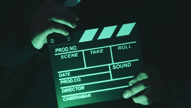 Video of anonymous person using a clapperboard in a local film production. Concept of film and video industry.