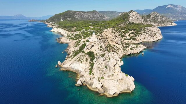 Aerial drone video of beautiful and picturesque cape Melagavi forming a small peninsula with unique lighthouse stand out next to archaeological site of Heraion, Loutraki, Greece