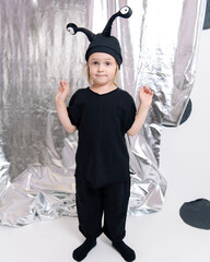 little girl in a black monster costume