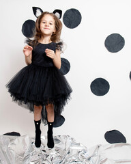 little girl in a black dress on a white background