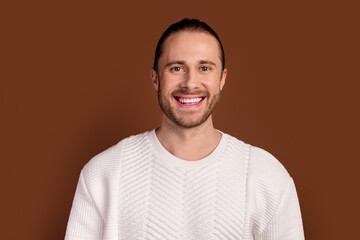 Photo of confident good mood guy dressed white pullover smiling white teeth isolated brown color background