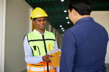 worker taking money from employer in the factory