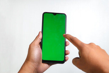 closeup of hands holding smart phones with green screen and showing using device isolated on white background, person sharing media transfer data files, touching monitor, free copy space