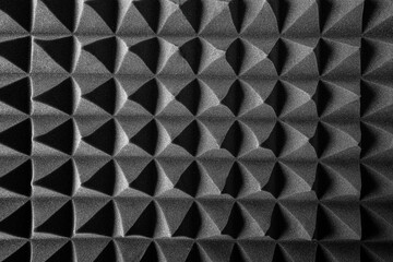 Black pyramids as an abstract background. Acoustic foam.