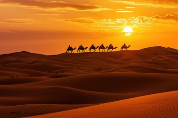 Silhouetted caravan of camels crossing desert at sunset.