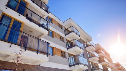 Modern apartment building in sunny day. Exterior, residential house facade. Residential area with...