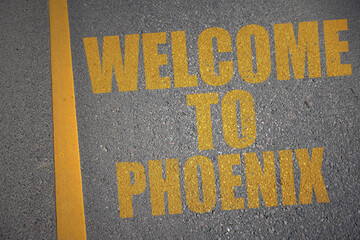 asphalt road with text welcome to phoenix near yellow line.