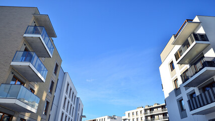 Modern apartment building in sunny day. Exterior, residential house facade. Residential area with...