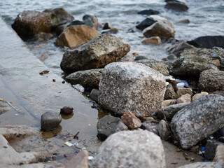 Nature's Coastal Symphony: A Serene Landscape of Blue Waves, Smooth Rocks, and White Foamy Shores.