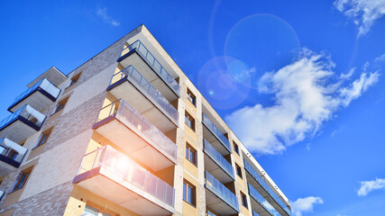 Modern apartment building in sunny day. Exterior, residential house facade. Residential area with...