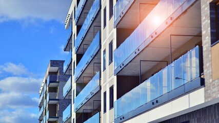 Modern apartment building in sunny day. Exterior, residential house facade. Residential area with...