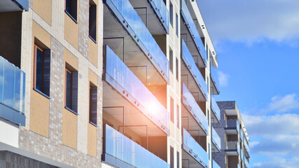 Modern apartment building in sunny day. Exterior, residential house facade. Residential area with modern, new and stylish living block of flats. 