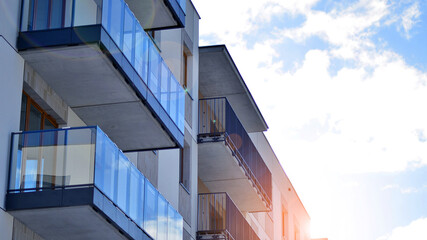 Fototapeta premium Modern apartment building in sunny day. Exterior, residential house facade. Residential area with modern, new and stylish living block of flats. 