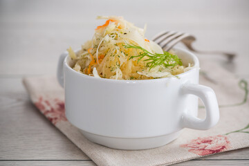 sauerkraut with carrots and spices in a white bowl