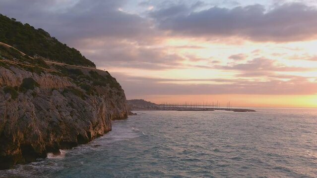 Water crashing against cliff in Costa del Garraf. Puerto Ginesta in distance, Barcelona