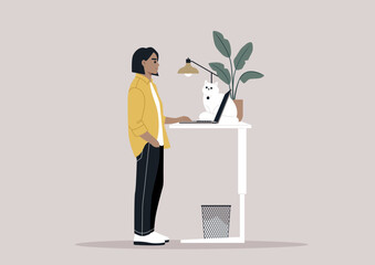 A young freelancer diligently working from home, their desk thoughtfully adjusted to a standing position, a setup believed to be beneficial for spinal health