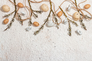 Festive Easter background with willow, eggs and vintage thread. Greeting card