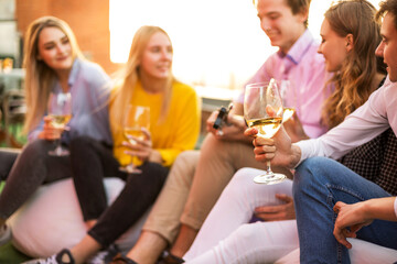 Cheerful friends drinking wine during party