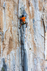 rock climber climbs the route.