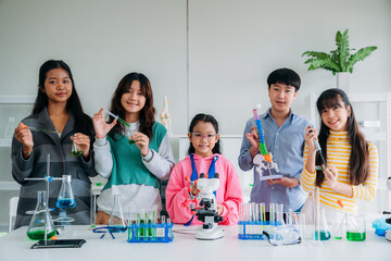 Group of Primary class children engaged in hands-on scientific experiments. Students discovering the wonders of science through interactive and engaging experiments.