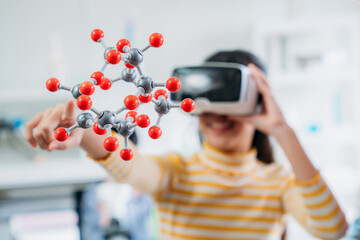 Child Explores Molecular Models with VR Glasses. Girl Wearing Reality Headset Interacts with 3D Molecule. Immersive STEM Education.