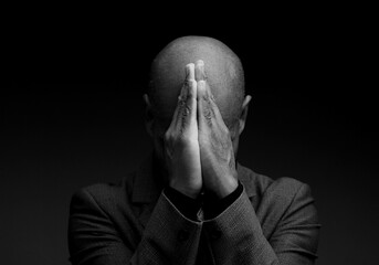 man praying to god Caribbean man praying with black grey background with people stock image stock...