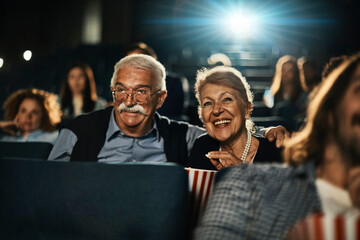 Senior couple watching a movie in cinema