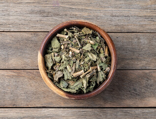 Lemon balm or Melissa dried tea leaves on a bowl over wooden table