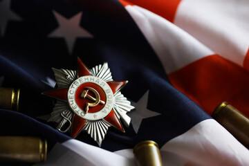 Many bullets cartridges and medals on United States flag. Concept of war glory victory. Gun...