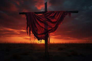Captivating sunset sky frames a cross draped in red cloth, evoking a powerful and spiritual ambiance. Perfect stock photo for religious, inspirational, and serene themes.