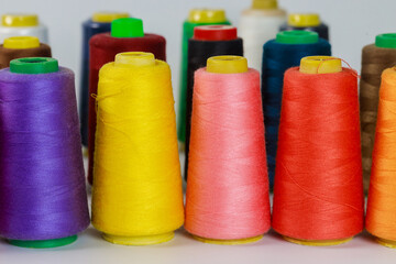For sewing, a set of colored thread spools.