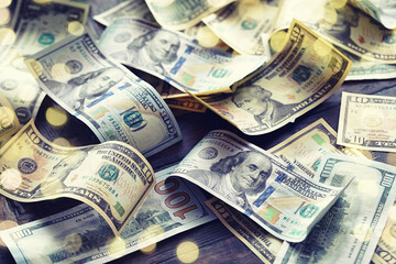 Money scattered on the desk. Money, US dollar bills background. Photography for Finance and Economy concepts.
