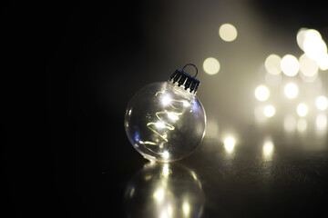 Christmas toy. Large glass golden ball on new year tree background. Interior decor for New Year's Eve