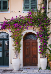 Fototapeta na wymiar Vintage Mediterranean old town street with traditional old houses, beautiful doors and windows, with bougainvillea.