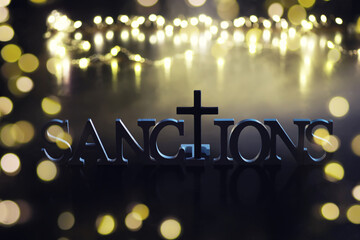 word sanctions spelled in letters on table made of wooden block letters with dramatic lighting and smoke - obrazy, fototapety, plakaty