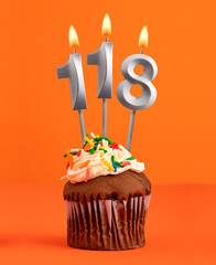 Number 118 candle - Birthday cupcake on orange background