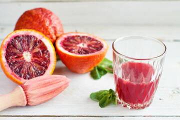 Close-up of Blood Orange Juice and Fresh Halves - 712603619
